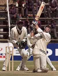 Zimbabwe batsman Andy Blignaut watches his drive to the boundary for a six watched by West Indies wicket keeper Courtney Brown on Monday.