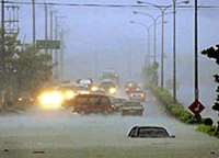 Cars lie submerged on a flooded highway in Taiwan's mountainous county of Nantou as typhoon Toraji slammed into eastern and central Taiwan on Monday. 