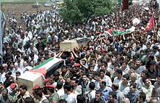 Palestinians carry the remains of the bodies of six men during their funeral in the village of Fara, near the West Bank city of Jenin, on Monday. 