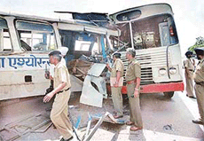 Police inspects the site where two buses of Haryana Roadways collided head on, on the Chandigarh-Zirakpur road near Chandigarh airport on Wednesday. 