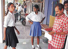 Victims of calamities or...: Girls from far-off places request a bystander for monetary aid in a market in Ludhiana.