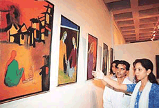 Masarat Mehboob of Srinagar explains her painting at an exhibition 