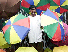 Sanjoy Panja, a street hawker, sells umbrellas in Kolkata on Thursday.
