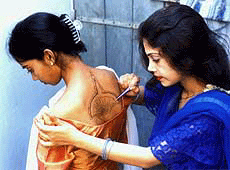 A woman applies mehndi