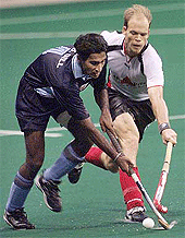 Germany's Bjorn Michel (R) and India's Sukhbir Singh Gill fight for a loose ball during their match at the Sultan Azlan Shah hockey tournament in Kuala Lumpur on Thursday. Germany beat India 2-0.