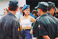 A young woman wearing a paratrooper's uniform.