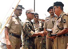 A militant surrendering before the Additional Director General of BSF, M.K. Singh.