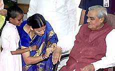 A woman tying a rakhee to Prime Minister Atal Bihari Vajpayee on the occasion of "raksha bandhan" at pm's residence in New Delhi on Saturday.