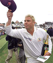 Australian bowler Shane Warne takes a bow, as he holds his man-of-the-match prize.