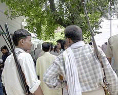 Two gunmen at the 13th day ceremony for Phoolan Devi at her residence in New Delhi on Monday.