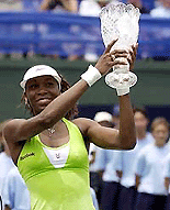 Venus Williams holds the champion's crystal trophy.
