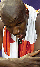 Donovan Bailey of Canada looks back at the field as he leaves after finishing his heat in the men's 100 metres semifinal at the World Championships in Athletics, in Edmonton on Sunday.