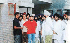 The Deputy Commissioner, Mr S.K. Sandhu, and other officials discuss the problems of the riot-hit families