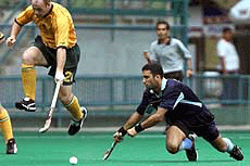 Aaron Hopkins of Australia (left) jumps as Deepak Thakur of India battles for the ball during their match of the 11th Sultan Azlan Shah Cup Hockey Tournament in Kuala Lumpur on Tuesday.