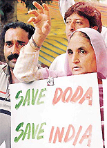 Relatives of villagers who were killed by militants after they were dragged from their homes into a field and shot in Doda district in Jammu and Kashmir state, protest near Parliament House in New Delhi, on Wednesday.