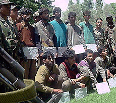 A group of Kashmiri youth who were apprehended by the Army near the LoC in Baramulla district being produced before mediapersons.