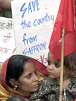 A communist activist along with her daughter takes part in an anti-government rally near Parliament in New Delhi on Thursday.