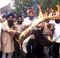Indian National Sikh Council activists burn the Pakistan national Flag near the Pakistan High Commission in New Delhi on Thursday. 