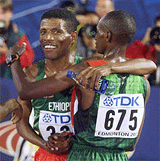 Charles Kamathi (675) of Kenya hugs Haile Gebrselassie of Ethiopia.