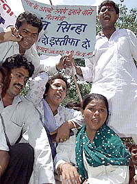 Activists of the youth wing of the Congress shout anti-government slogans near Finance Minister Yashwant Sinha's residence in New Delhi on Friday.