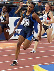 Marion Jones (830) of the USA rounds a turn during her heat in the womens 200 m qualifier 