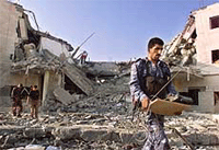 Palestinian police remove equipment from the rubble.