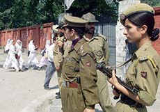 Police officers keep guard near the main entrance of the Government College for Women