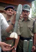 Border Security Force men display a 60 mm mortar shell.