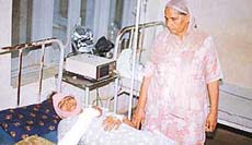 Gurmel Kaur in a Raikot hospital on Saturday after her husband attacked her.