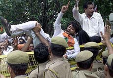 An Indian demonstrator from the Bharatiya Janata Party (BJP) shouts anti-Pakistan slogans after being pushed off a barricade by police officers during a demonstration near the Pakistan High Commission in New Delhi on Saturday.