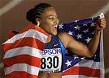 Marion Jones of the USA celebrates with the American flag.