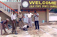 police personnel sanitising mini-stadium in Jammu.