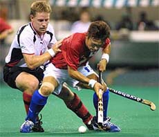 South Koreas Yoo Moon Ki (R) is challenged by Germanys Tibor Weissenborn during the final of the Sultan Azlan Shah hockey tournament in Kuala Lumpur on Sunday.