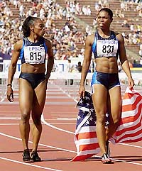 The USA's Anjanette Kirkland holds the US flag while celebrating her first place finish in the women's 100 meter hurdles final while second place finisher and teammate Gail Devers looks at her at the World Championships in athletics in Edmonton on Saturday.