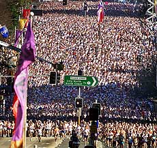 Thousands of runners sprint along William Street after the start of the annual City to Surf fun run in Sydney on Sunday.