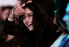 Indian film actress Kajol Devgan laughs during the grand finale of the fashion-week 