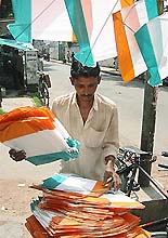 A street vendor sorts out kites 