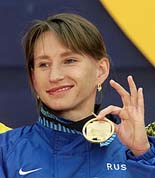 Olga Yegorova of Russia shows off her Gold medal, which she received for her first place finish in t he women's 5000 meter final at the World Championships in athletics in Edmonton on Sunday.