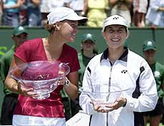 Lindsay Davenport, left, and Monica Seles hold up their trophies.