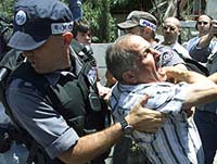 A Palestinian protester is arrested during scuffles with Israeli police near Orient House in East Jerusalem on Monday.