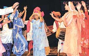 FEEL FREE TO DANCE ADVISER: The Adviser to the UT Administrator, Ms Neeru Nanda, shares the stage with the bhangra team of the Sector 45 St Stephens School at an Independence Day eve function in Tagore Theatre, Chandigarh, on Tuesday. 