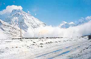 A file photo of a Snow and Avalanche Studies Establishment camp in the Siachen sector with a powder avalanche forming in the backdrop.