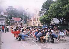 Tourists and locals enjoy a brief spell of sunshine.