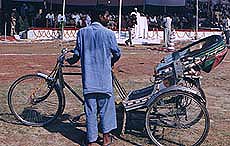 A sweat-soaked rickshaw puller.