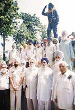Members of the Indian Ex-Services League (Punjab and Chandigarh) stand in front of the statue of Fit-Lt Nirmaljit Singh Sekhon