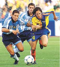 Argentina's Diego Simeone (L) battles Ecuador's Marlon Ayovi in first half action of their World Cup qualifying match in Quito on Wednesday. 