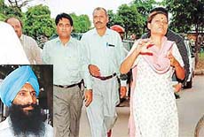 Dr Asha Kiran along with her husband Vinod Kumar being taken to the court of the UT Chief Judicial Magistrate in an alleged fake medical certificate case, in Chandigarh on Friday. Inset, the complainant Gurbax Singh.