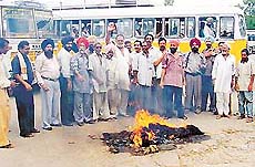 Punjab Roadways employees burn an effigy of Chief Minister Parkash Singh Badal in Ludhiana on Friday, protesting against the anti-worker policies of the government.