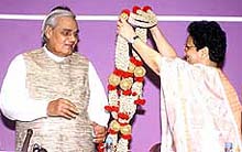 Prime Minister Atal Behari Vajpayee being greeted by MP Mabel Rebelio at a discussion