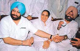 PPCC President Amarinder Singh, Convener of Congress Parliamentary group Jagmeet Brar and former Chief Minister Rajinder Kaur Bhattal (centre) hold hands to express unity at Mansa on Saturday.